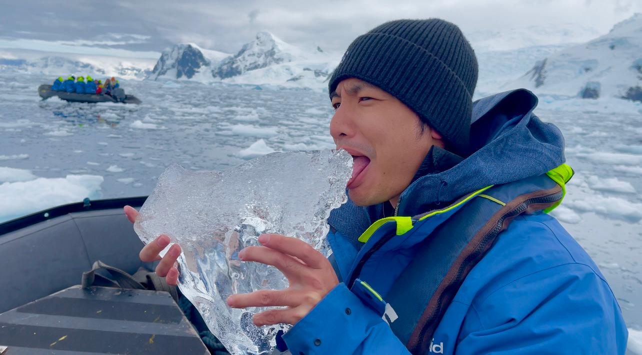 chimu adventures antarctica peninsula traveler holding ice aaron 24 25